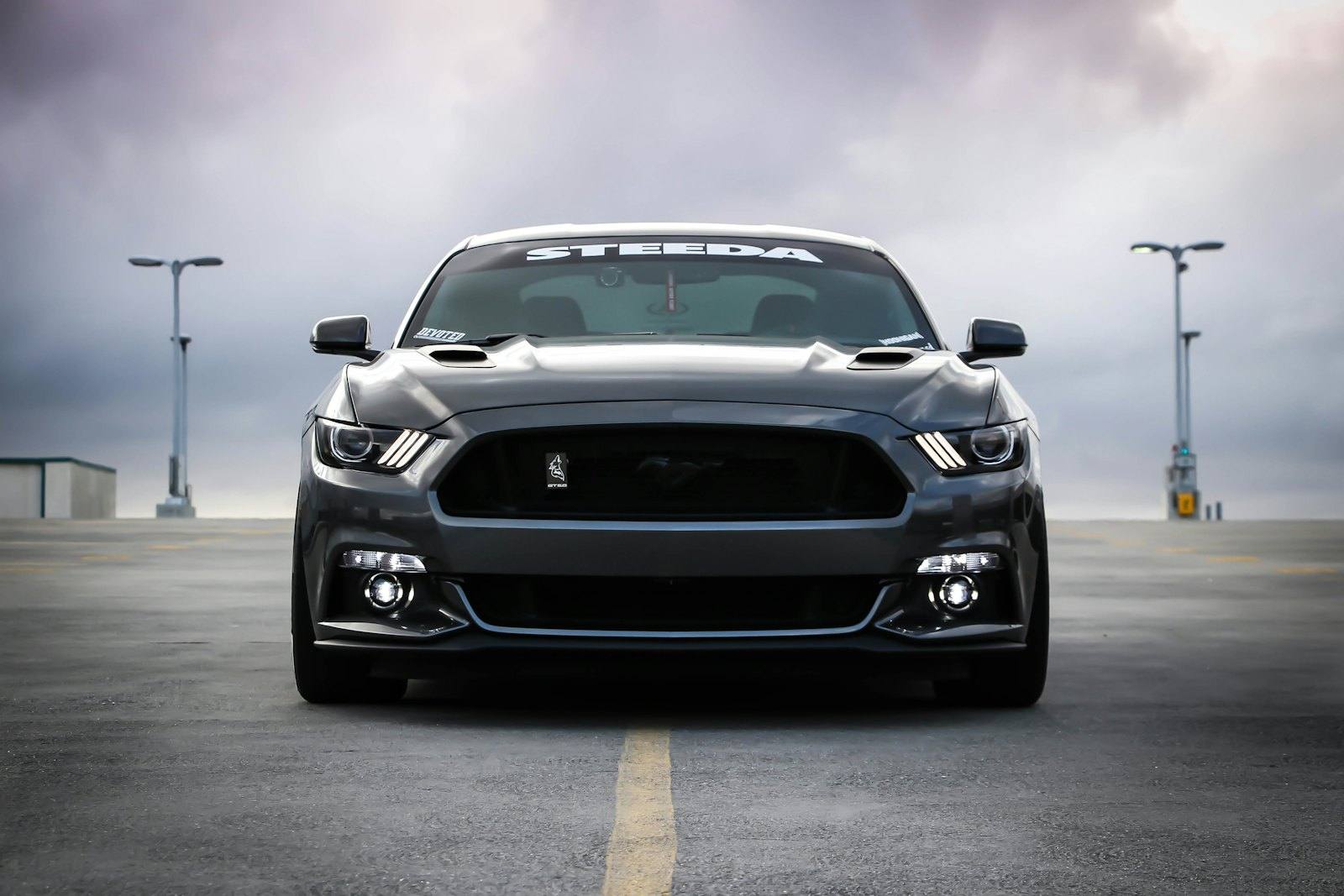 Dark grey sports coupe facing the camera